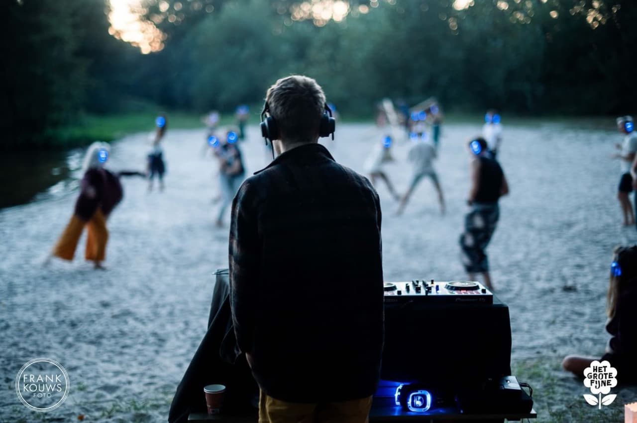 Henners DJing a silent disco on the beach at Het Groete Fijn festival